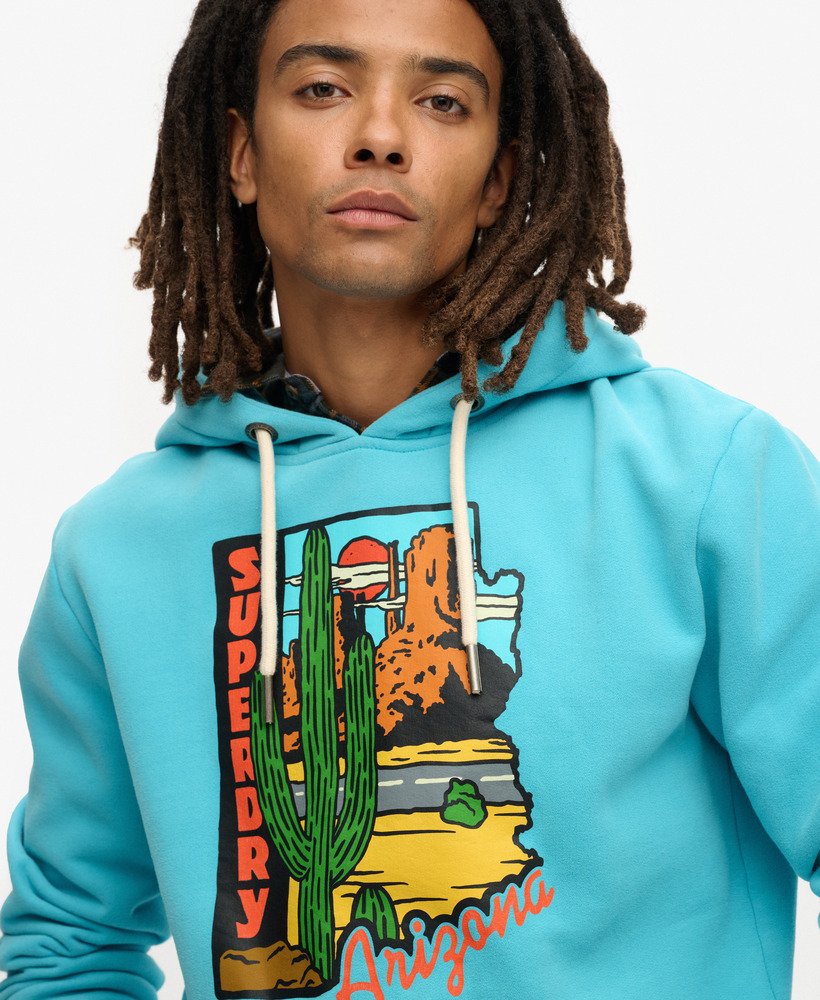 bluza z kapturem z grafiką pocztówki podróżnej w kolorze maui blue