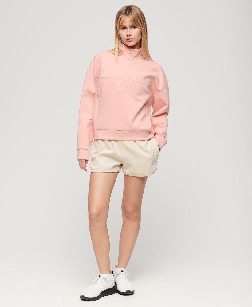 sport tech relaxed half zip w kolorze brzoskwiniowo-różowym