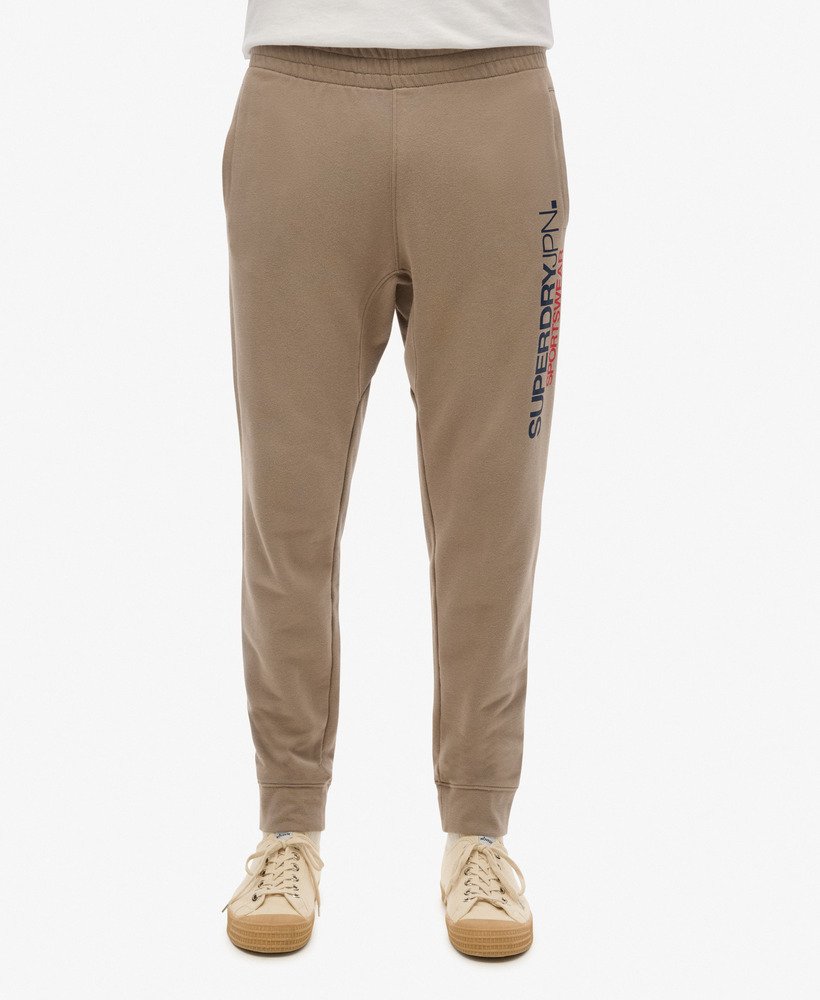 spodnie dresowe sportswear z logo zwężanym dołem w kolorze głębokiego beżu slub