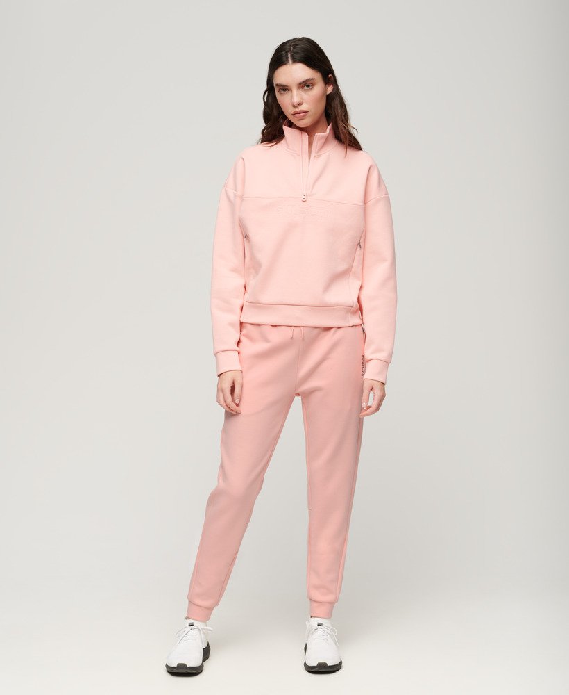 spodnie dresowe sports tech slim joggers w kolorze brzoskwiniowo-perłowym